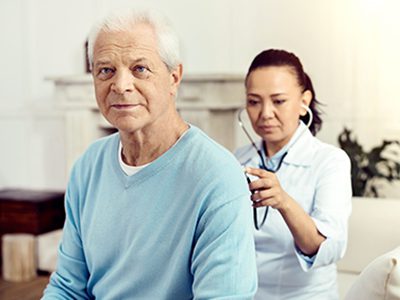 Thoughtful elderly man checking lungs at hospital