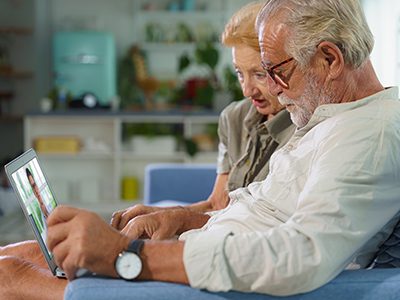 caucasian senior couple stay home and call medical doctor via telemedicine service to ask for medical advise using laptop